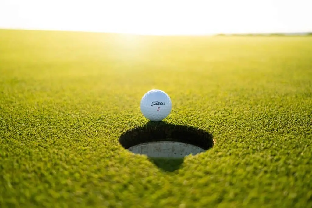 Golf ball on the edge of the cup at a charity golf tournament