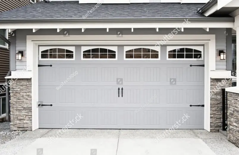 White carriage-style garage door with arched windows