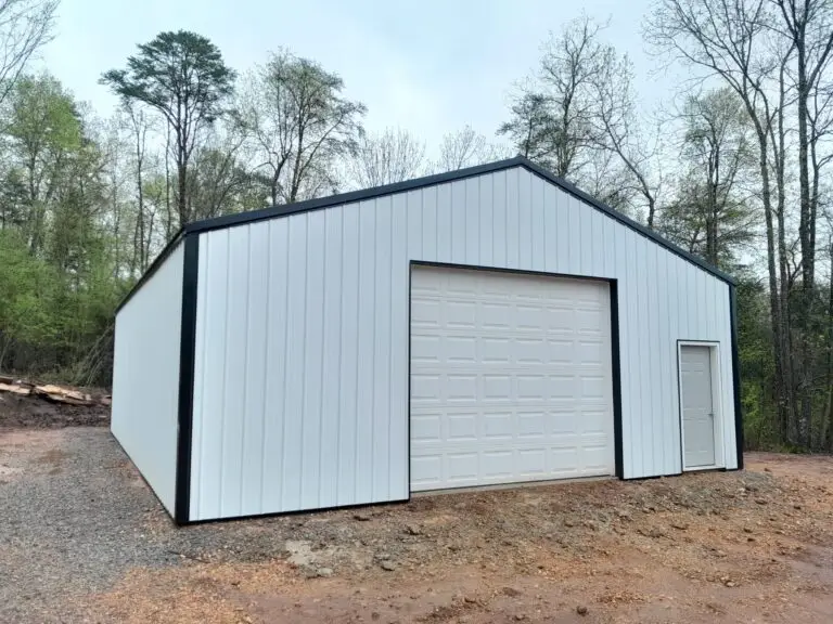 30 x 40 x 12 garage with a white roll-up door and black trim