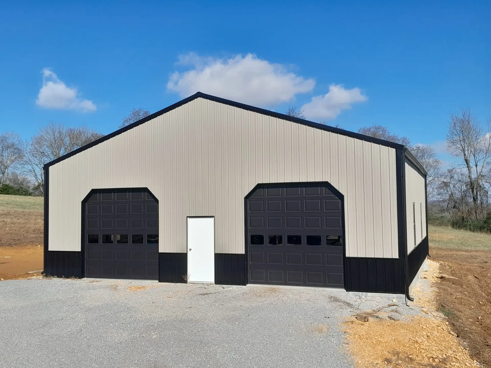 40 x 60 x 12 garage, tan metal with two black garage doors