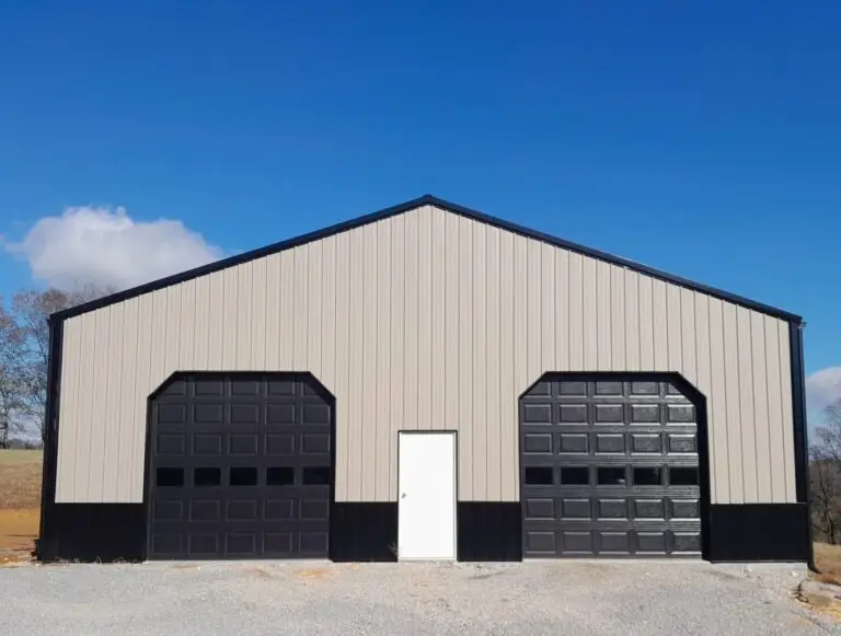 Front of the 40 x 60 x 12 garage with black garage doors and a white walk door