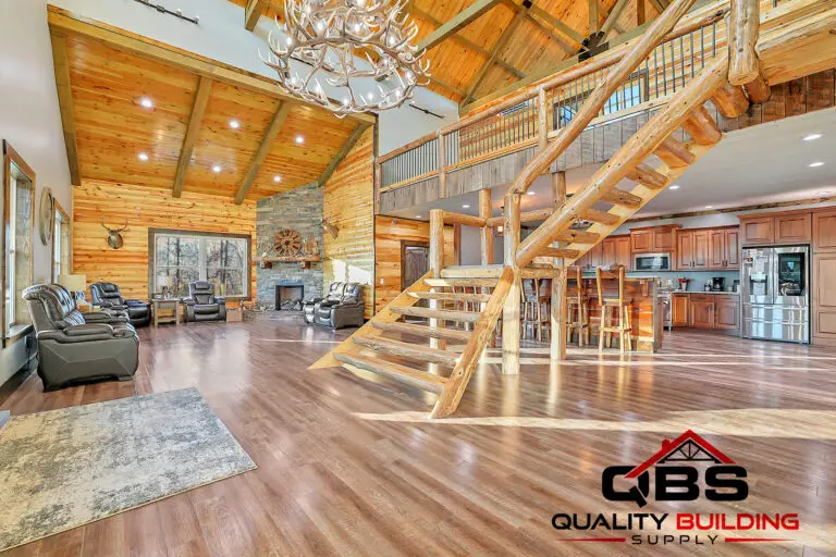 Great room with a wood staircase, tongue-and-groove ceiling and chandelier in the South Fork Barndo