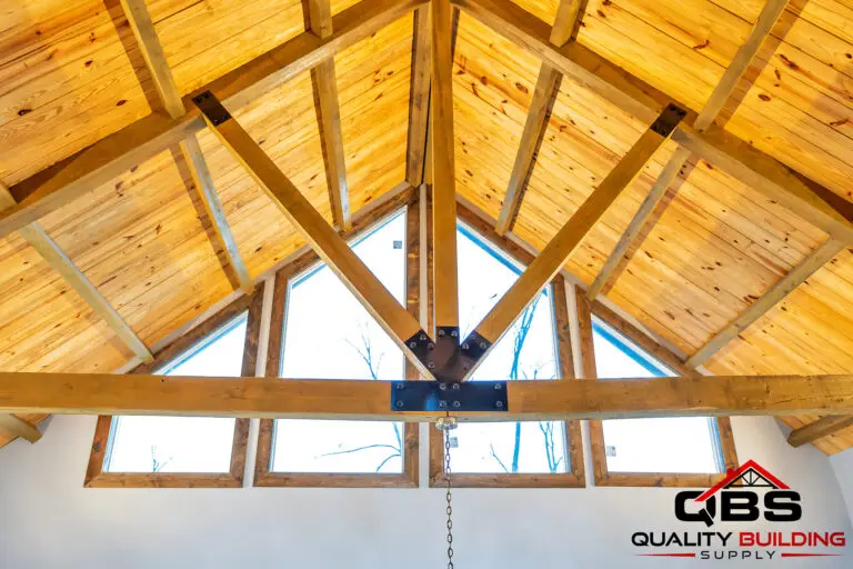Vaulted tongue-and-groove ceiling with timber trusses and gable windows in the South Fork Barndo