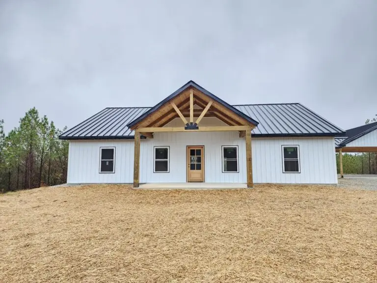 Viewpoint barndominium, white with a timber gable porch