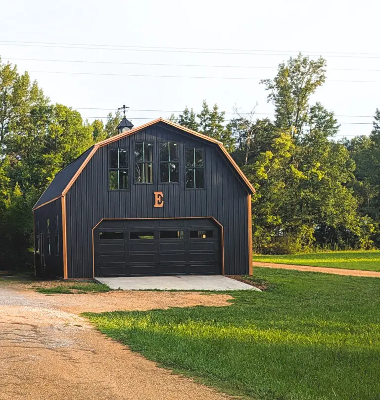 The Dutch Barn, black gambrel garage with a curved roof