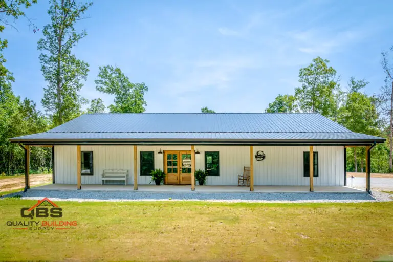 Smith barndominium, white with a blue metal roof and porch