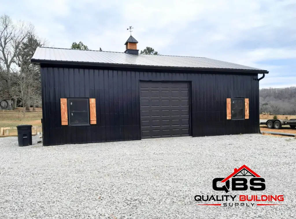 Front of the 30 x 40 x 12 garage, black with a cupola and roll-up door