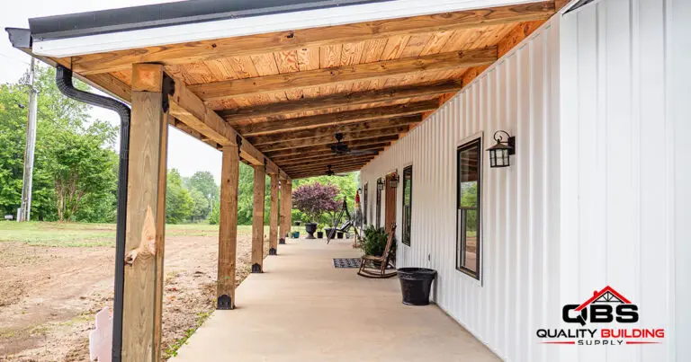 Covered porch with a wood ceiling along the White Oak barndominium