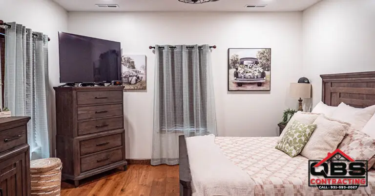 Bedroom with a wood dresser in the White Oak barndominium