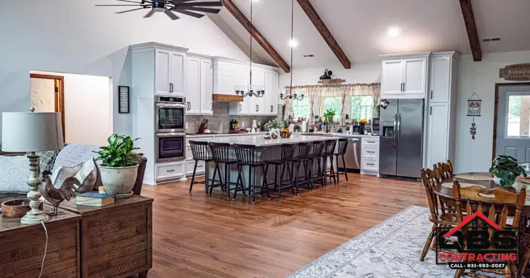 Kitchen with stainless appliances and island seating in the White Oak barndominium