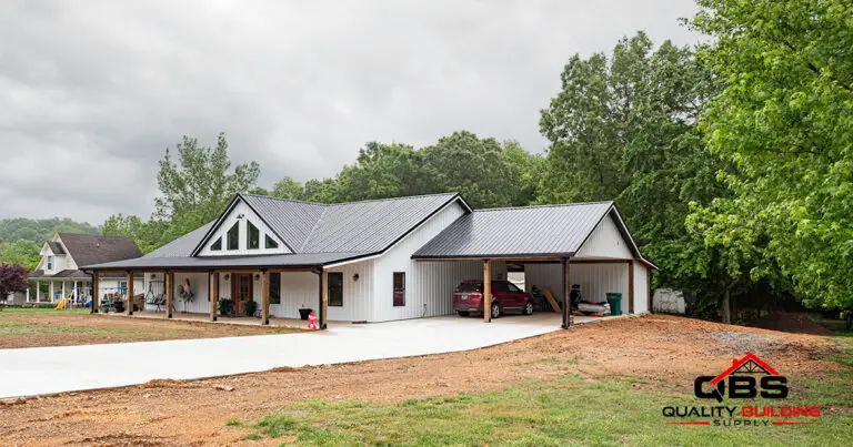 The White Oak barndominium, white with an attached carport