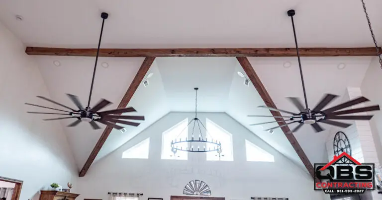 Vaulted ceiling with wood beams and gable window in the White Oak barndominium