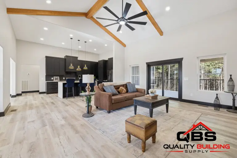 Vaulted great room with wood beams and a ceiling fan in the Ironwood barndominium