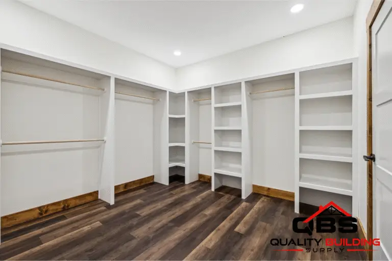 Walk-in closet with built-in shelves in the Ozark barndominium