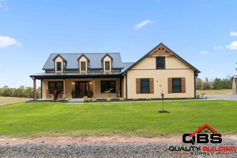 The Oak Grove barndominium, tan board-and-batten with dormers and a front porch