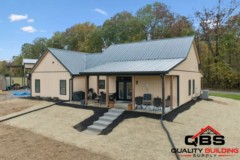 The Oak Grove barndominium, tan siding with a covered front porch and steps