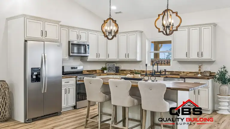 Kitchen with white cabinets and island seating in the Cobalt Combo