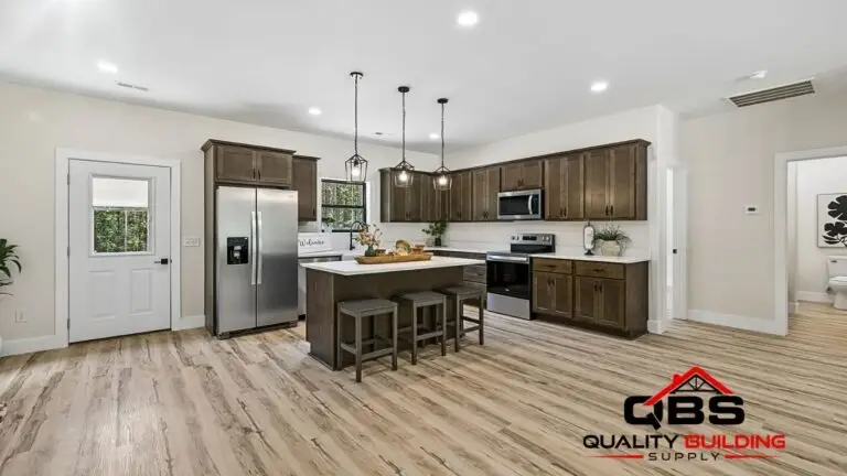 Kitchen with dark wood cabinets and pendant lights in the Saddlebrook barndominium