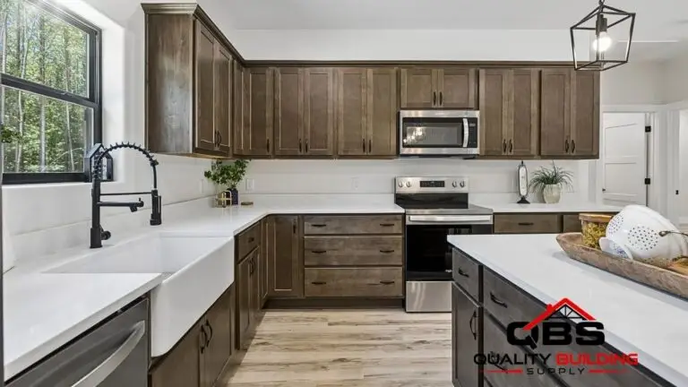 Kitchen with dark wood cabinets and a farmhouse sink in the Saddlebrook barndominium