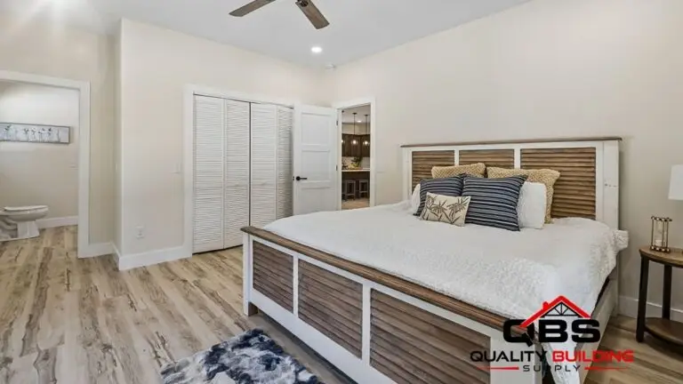 Bedroom with a wood bed frame in the Saddlebrook barndominium