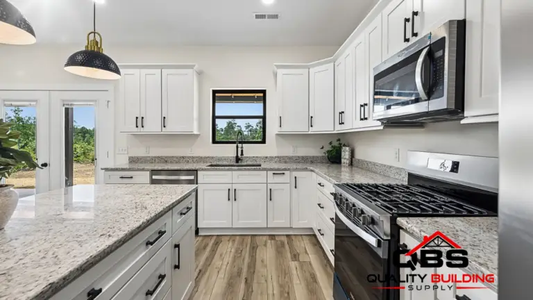 Kitchen with white cabinets and granite counters in the Smith V2 barndominium