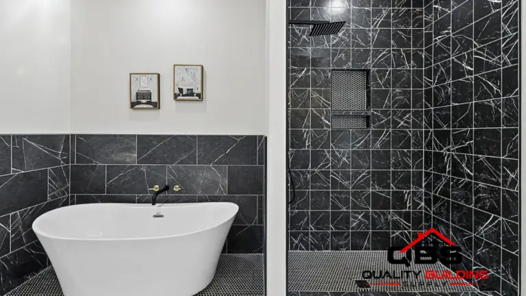 Soaking tub beside a black tile shower in the Smith V2 barndominium