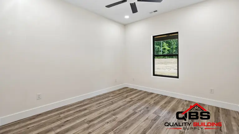 Empty bedroom with wood floors in the Smith V2 barndominium