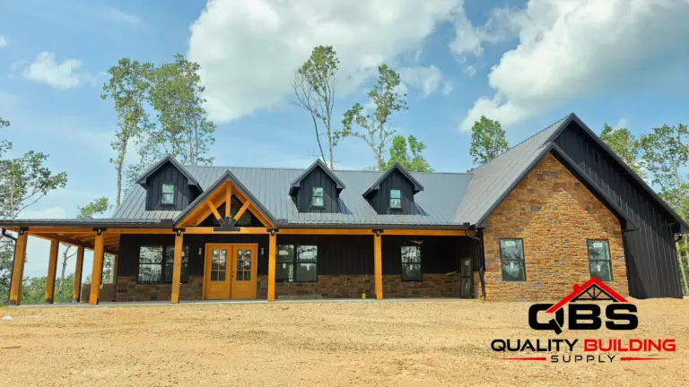 The Black Ridge barndominium roofline among the trees