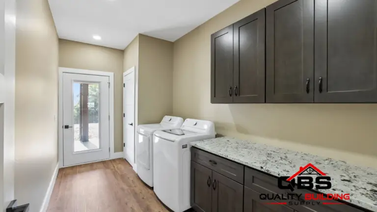 Laundry room with dark cabinets in the Shady Grove barndominium