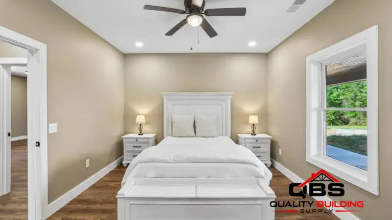Bedroom with a white bed and ceiling fan in the Shady Grove barndominium